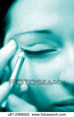 Stock Image - Woman making her eyelashes... Fotosearch