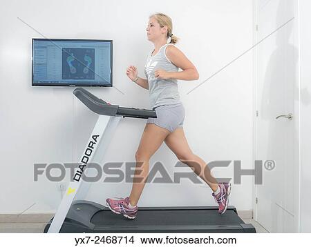 Woman on a running machine. View Large Photo Image Picture - Woman on a running machine.. Fotosearch