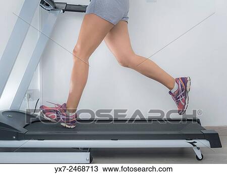 Woman on a running machine. View Large Photo Image Stock Image - Woman on a running machine.. Fotosearch
