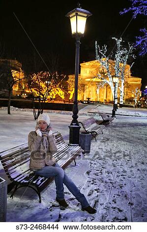 Picture - Woman posing front the State Academic Bolshoi Theatre Opera and Ballet Moscow, Russia. Fotosearch