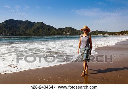 Woman walking on the beach, Pacific Ocean, Manzanillo, Colima, Mexico View Large Photo Image Stock Photo - Woman walking on the beach, Pacific Ocean, Manzanillo, Colima, Mexico. Fotosearch