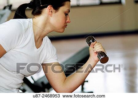 Young woman exercising in gym.. View Large Photo Image Stock Image - Young woman exercising in gym... Fotosearch