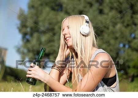 Young woman listening to music View Large Photo Image Stock Photo - Young woman listening to music. Fotosearch