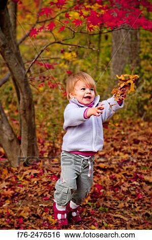1 year old girl playing with autumn leaves.. View Large Photo Image Stock Photograph - 1 year old girl playing with autumn leaves... Fotosearch