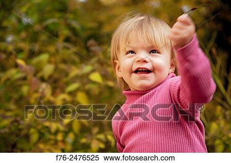 1 year old girl playing with autumn leaves.. View Large Photo Image Stock Photography - 1 year old girl playing with autumn leaves... Fotosearch