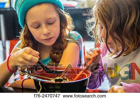 10 year old girl with woolen cap on and her 6 year old sister, eating noodles in a noodle restaurant in Berkeley, CA, View Large Photo Image Stock Photo - 10 year old girl with woolen cap on and her 6 year old sister, eating noodles in a noodle restaurant in Berkeley, CA,. Fotosearch