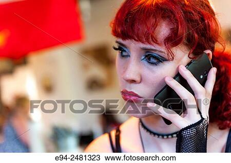 23 year old red head woman talking on a cell phone in a restaurant. View Large Photo Image Stock Image - 23 year old red head woman talking on a cell phone in a restaurant.. Fotosearch