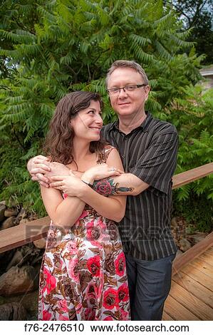 30ish couple warmly embracing on wooden walkway in Gloucester, MA models released, G110807_1 and G110808_2. View Large Photo Image Stock Image - 30ish couple warmly embracing on wooden walkway in Gloucester, MA models released, G110807_1 and G110808_2.. Fotosearch