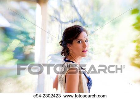 36 year old brunette woman outdoors standing on a porch of an old house looking over her shoulder directly at the camera. View Large Photo Image Stock Image - 36 year old brunette woman outdoors standing on a porch of an old house looking over her shoulder directly at the camera.. Fotosearch