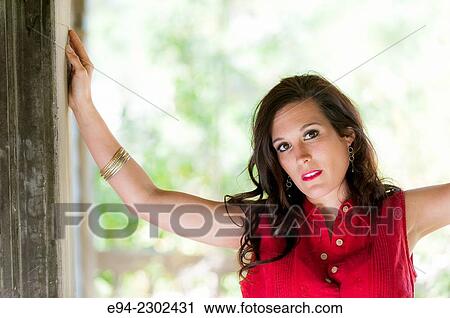 36 year old brunette woman outdoors standing in the doorway of an old house looking directly at the camera. View Large Photo Image Stock Image - 36 year old brunette woman outdoors standing in the doorway of an old house looking directly at the camera.. Fotosearch