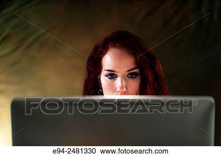 37 year old redheaded woman looking down at a computer screen. View Large Photo Image Stock Image - 37 year old redheaded woman looking down at a computer screen.. Fotosearch