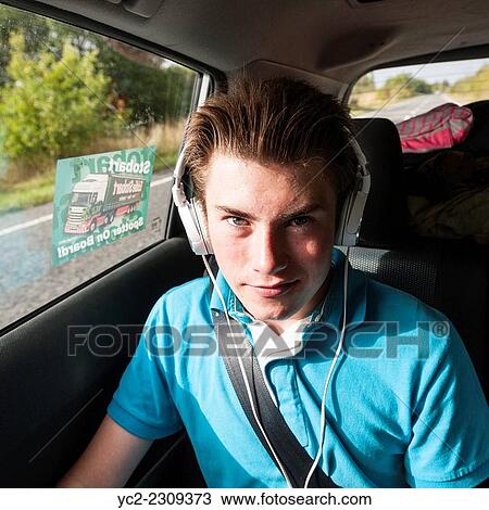 A 14 year old boy listening to music in the car. View Large Photo Image Stock Image - A 14 year old boy listening to music in the car.. Fotosearch