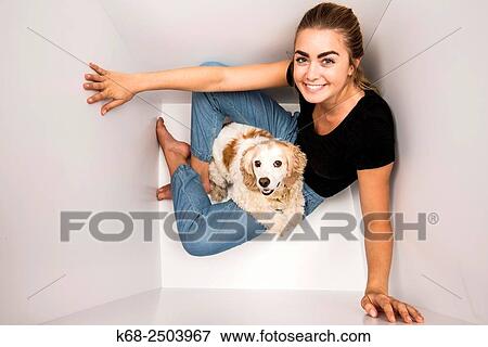 a 19 year old woman with her cocker spaniel in a white box. View Large Photo Image Stock Photo - a 19 year old woman with her cocker spaniel in a white box.. Fotosearch