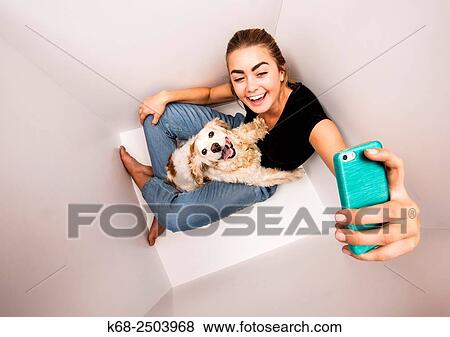 a 19 year old woman with her cocker spaniel in a white box. View Large Photo Image Stock Photo - a 19 year old woman with her cocker spaniel in a white box.. Fotosearch