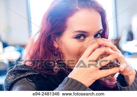 A 37 year old redheaded woman drinking coffee in a cafe, looking at the camera. View Large Photo Image Stock Photograph - A 37 year old redheaded woman drinking coffee in a cafe, looking at the camera.. Fotosearch