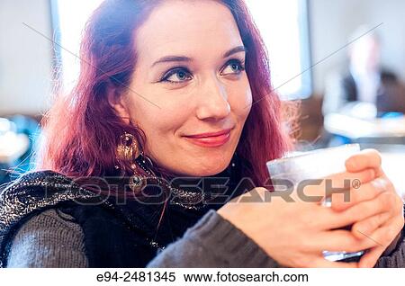 A 37 year old redheaded woman drinking coffee in a cafe, looking away from the camera. View Large Photo Image Stock Photography - A 37 year old redheaded woman drinking coffee in a cafe, looking away from the camera.. Fotosearch