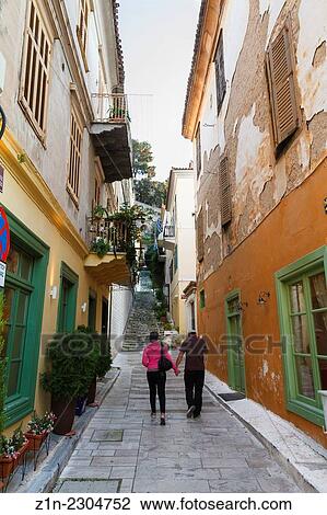 A couple walking at alley in Nafplion city. Argolis, Peloponnese, Greece. View Large Photo Image Stock Image - A couple walking at alley in Nafplion city. Argolis, Peloponnese, Greece.. Fotosearch