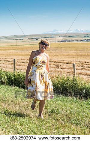 a woman, 65, in farm land in southern Alberta, Canada. View Large Photo Image Picture - a woman, 65, in farm land in southern Alberta, Canada.. Fotosearch