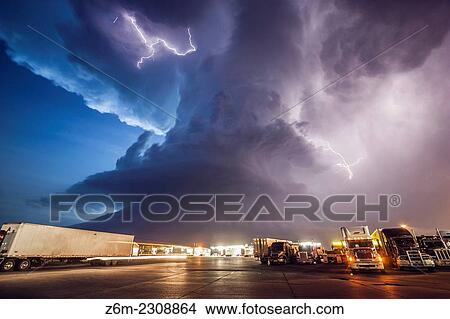 Amazing supercell storm during twilight nears a York Nebraska truck stop on I80 as it spits out lightning, June 17, 2009. Only a half hour or so earlier this storm was producing a long-lived large tornado near Aurora Nebraska. View Large Photo Image Picture - Amazing supercell storm during twilight nears a York Nebraska truck stop on I80 as it spits out lightning, June 17, 2009. Only a half hour or so earlier this storm was producing a long-lived large tornado near Aurora Nebraska.. Fotosearch