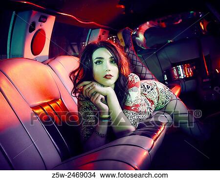 Attractive brunette girl posing inside the limousine. View Large Photo Image Picture - Attractive brunette girl posing inside the limousine.. Fotosearch