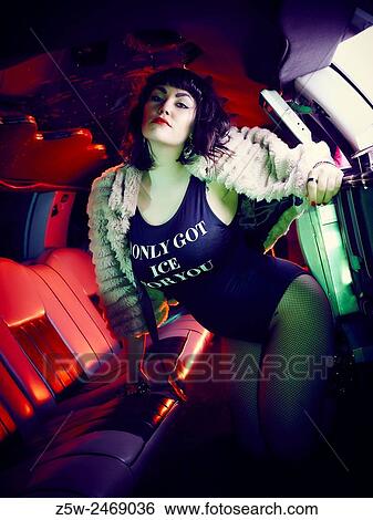 Attractive brunette girl posing inside the limousine. View Large Photo Image Stock Photograph - Attractive brunette girl posing inside the limousine.. Fotosearch
