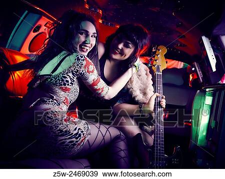 Attractive girl friends posing together inside the limousine. View Large Photo Image Stock Photo - Attractive girl friends posing together inside the limousine.. Fotosearch
