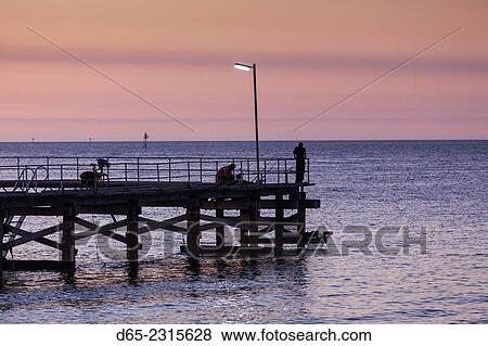 Stock Photo - Australia, South Australia, Yorke Peninsula, Wallaroo, town jetty, sunset.. Fotosearch