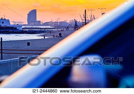Beach at sunset. First, detail of a blurred car. In the background, beach and Hotel W by Ricardo Bofill architect. Hotel W, aka Vela Hotel, highlighting silhouette on the horizon. Barcelona, Catalonia, Spain. View Large Photo Image Stock Image - Beach at sunset. First, detail of a blurred car. In the background, beach and Hotel W by Ricardo Bofill architect. Hotel W, aka Vela Hotel, highlighting silhouette on the horizon. Barcelona, Catalonia, Spain.. Fotosearch