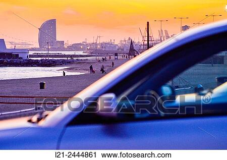 Beach at sunset. First, detail of a blurred car. In the background, beach and Hotel W by Ricardo Bofill architect. Hotel W, aka Vela Hotel, highlighting silhouette on the horizon. Barcelona, Catalonia, Spain. View Large Photo Image Stock Image - Beach at sunset. First, detail of a blurred car. In the background, beach and Hotel W by Ricardo Bofill architect. Hotel W, aka Vela Hotel, highlighting silhouette on the horizon. Barcelona, Catalonia, Spain.. Fotosearch