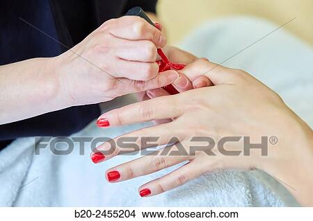 Beautician painting nails a woman. Manicure. Hairdressing salon and Beauty Clinic. View Large Photo Image Picture - Beautician painting nails a woman. Manicure. Hairdressing salon and Beauty Clinic.. Fotosearch