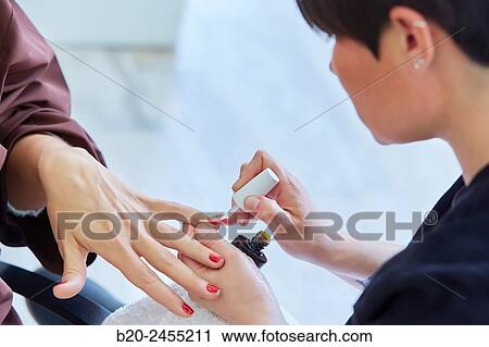 Beautician painting nails a woman. Manicure. Hairdressing salon and Beauty Clinic. View Large Photo Image Stock Image - Beautician painting nails a woman. Manicure. Hairdressing salon and Beauty Clinic.. Fotosearch