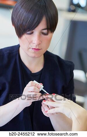 Beautician painting nails a woman. Manicure. Hairdressing salon and Beauty Clinic. View Large Photo Image Stock Image - Beautician painting nails a woman. Manicure. Hairdressing salon and Beauty Clinic.. Fotosearch