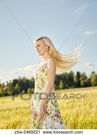 Beautiful fair skin blonde wearing a floral dress, summer sunlight, barley field on background. View Large Photo Image Stock Image - Beautiful fair skin blonde wearing a floral dress, summer sunlight, barley field on background.. Fotosearch