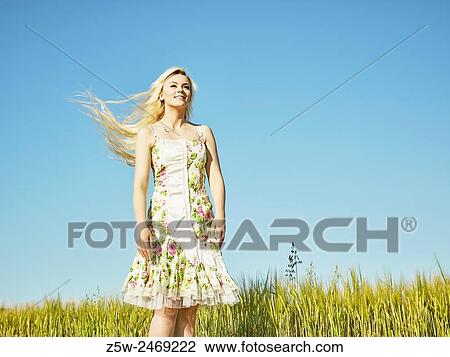 Beautiful fair skin blonde wearing a floral dress, summer sunlight, barley field on background. View Large Photo Image Stock Image - Beautiful fair skin blonde wearing a floral dress, summer sunlight, barley field on background.. Fotosearch