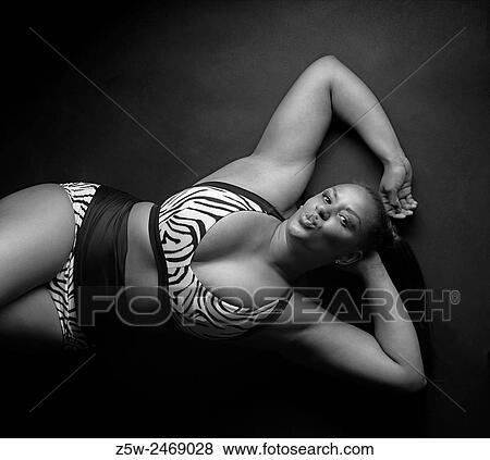 Beautiful mixed race woman lying and posing, black and white image. View Large Photo Image Stock Photo - Beautiful mixed race woman lying and posing, black and white image.. Fotosearch