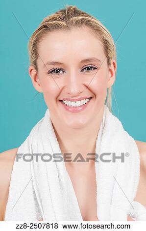 Stock Photo - Beautiful young Caucasian woman with a white towel smiling.. Fotosearch