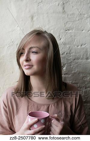 Beautiful young woman drinking coffee looking away. View Large Photo Image Stock Image - Beautiful young woman drinking coffee looking away.. Fotosearch