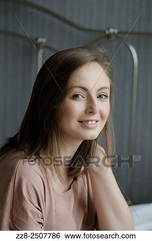 Stock Photograph - Beautiful young woman smiling.. Fotosearch