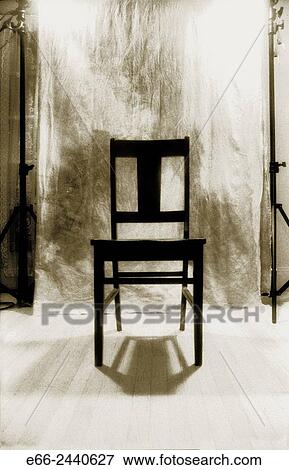 Stock Photo - Black and white infrared shot of black chair in front of backdrop in studio.. Fotosearch