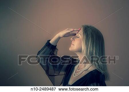 Stock Photo - Blond woman wearing a costume.. Fotosearch