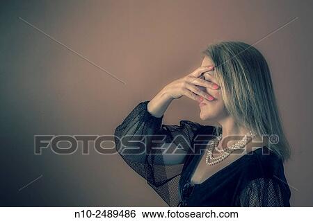 Stock Photograph - Blond woman wearing a costume.. Fotosearch
