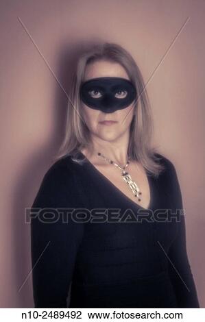 Blond woman wearing a mask. View Large Photo Image Stock Image - Blond woman wearing a mask.. Fotosearch