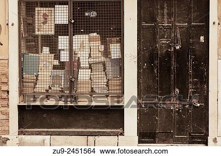 Books stacked up in an old locked bookshop in the Castello district, Venice, Veneto, Italy, Europe. View Large Photo Image Picture - Books stacked up in an old locked bookshop in the Castello district, Venice, Veneto, Italy, Europe.. Fotosearch