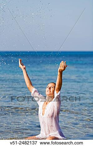 Brunette beautiful woman enjoying bath at the sea View Large Photo Image Stock Photo - Brunette beautiful woman enjoying bath at the sea. Fotosearch