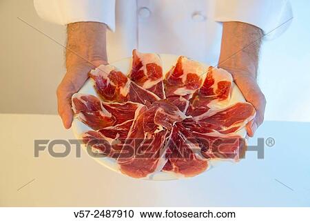 Chef holding a platter of Iberian ham. View Large Photo Image Stock Image - Chef holding a platter of Iberian ham.. Fotosearch