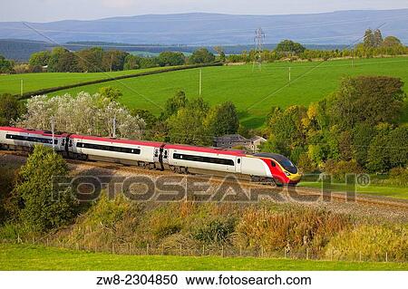 Class 390 Pendolino Virgin train passing Strickland Mill, Great Strickland, Cumbria, West Coast Main Line, England, UK. View Large Photo Image Stock Image - Class 390 Pendolino Virgin train passing Strickland Mill, Great Strickland, Cumbria, West Coast Main Line, England, UK.. Fotosearch