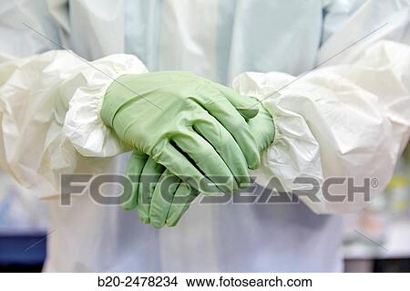 Picture - Cleaning hands, Personal protective equipment, protection for the care of patients with infectious diseases (Ebola), Drugs store, Nursing station, Hospital Donostia, San Sebastian, Gipuzkoa, Basque Country, Spain. Fotosearch
