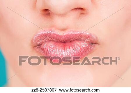 Stock Photo - Close up of a young Caucasian woman pouting.. Fotosearch
