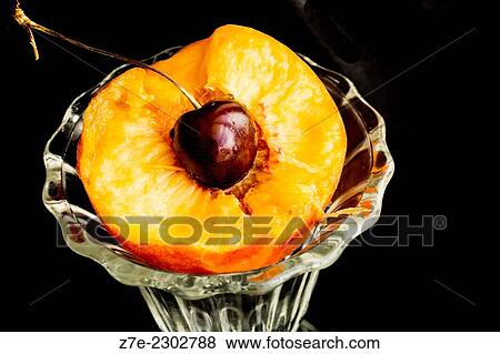 close-up of half a peach with cherry in center in a dessert glass. View Large Photo Image Stock Photo - close-up of half a peach with cherry in center in a dessert glass.. Fotosearch
