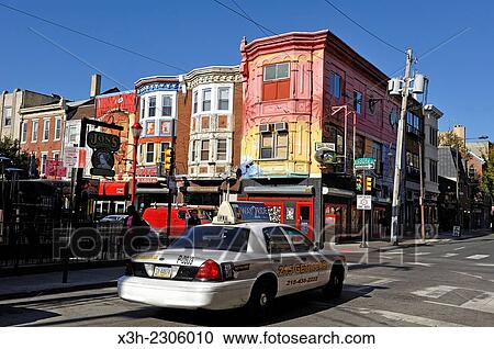 Stock Image - colored houses in South Street at the intersection with 3rd Street, Philadelphia, Commonwealth of Pennsylvania, Northeastern United States,.. Fotosearch